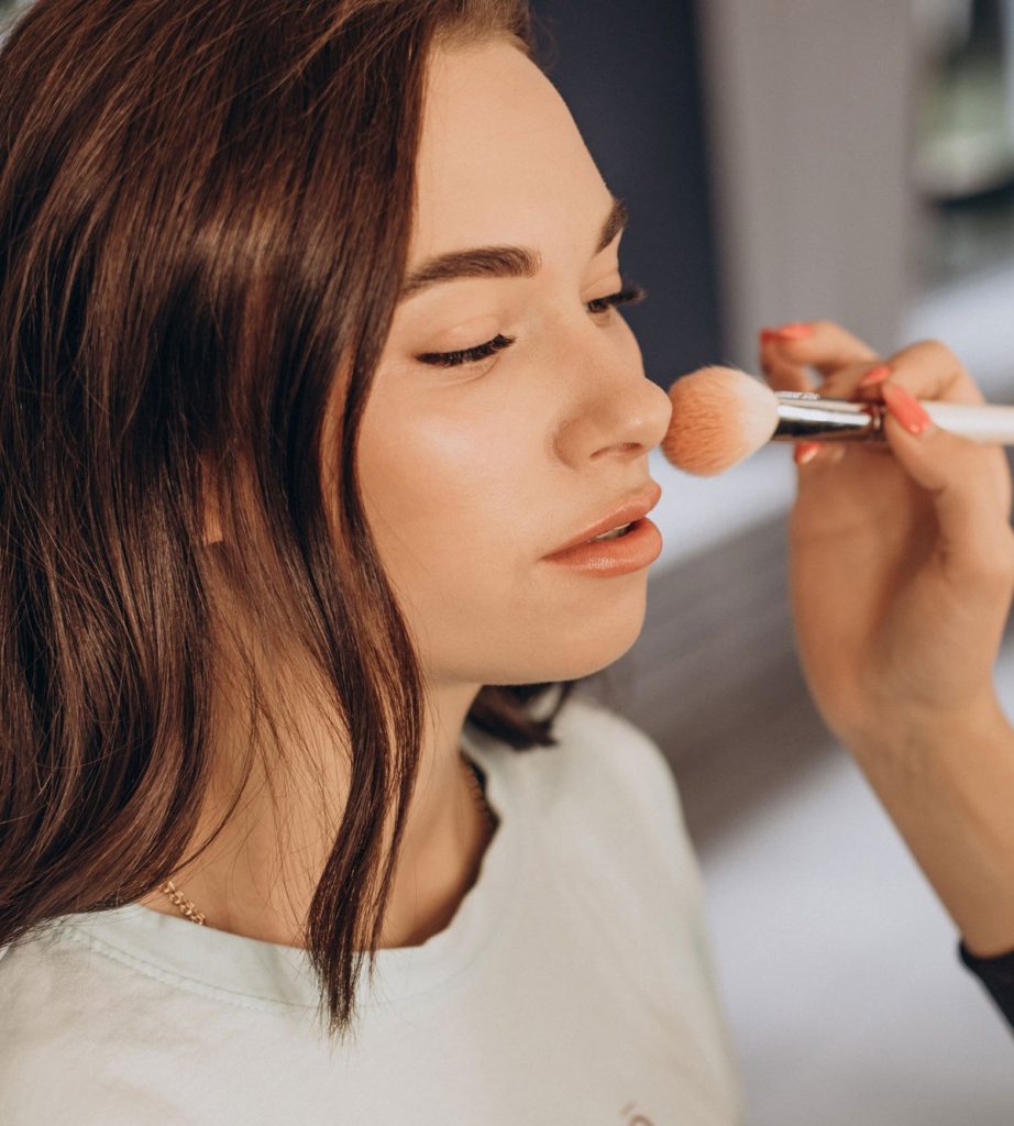 A woman is getting her face painted